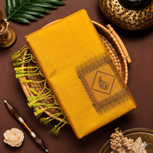 Mustard yellow soft silk saree with Meena work pallu and lime green tassels