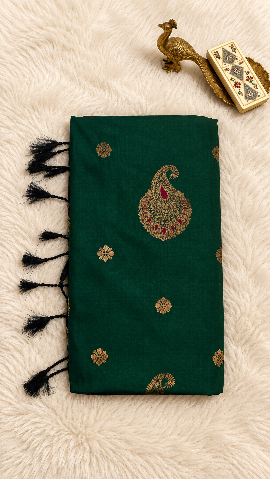 Bottle green soft silk saree with gold zari paisley butta and black tassels