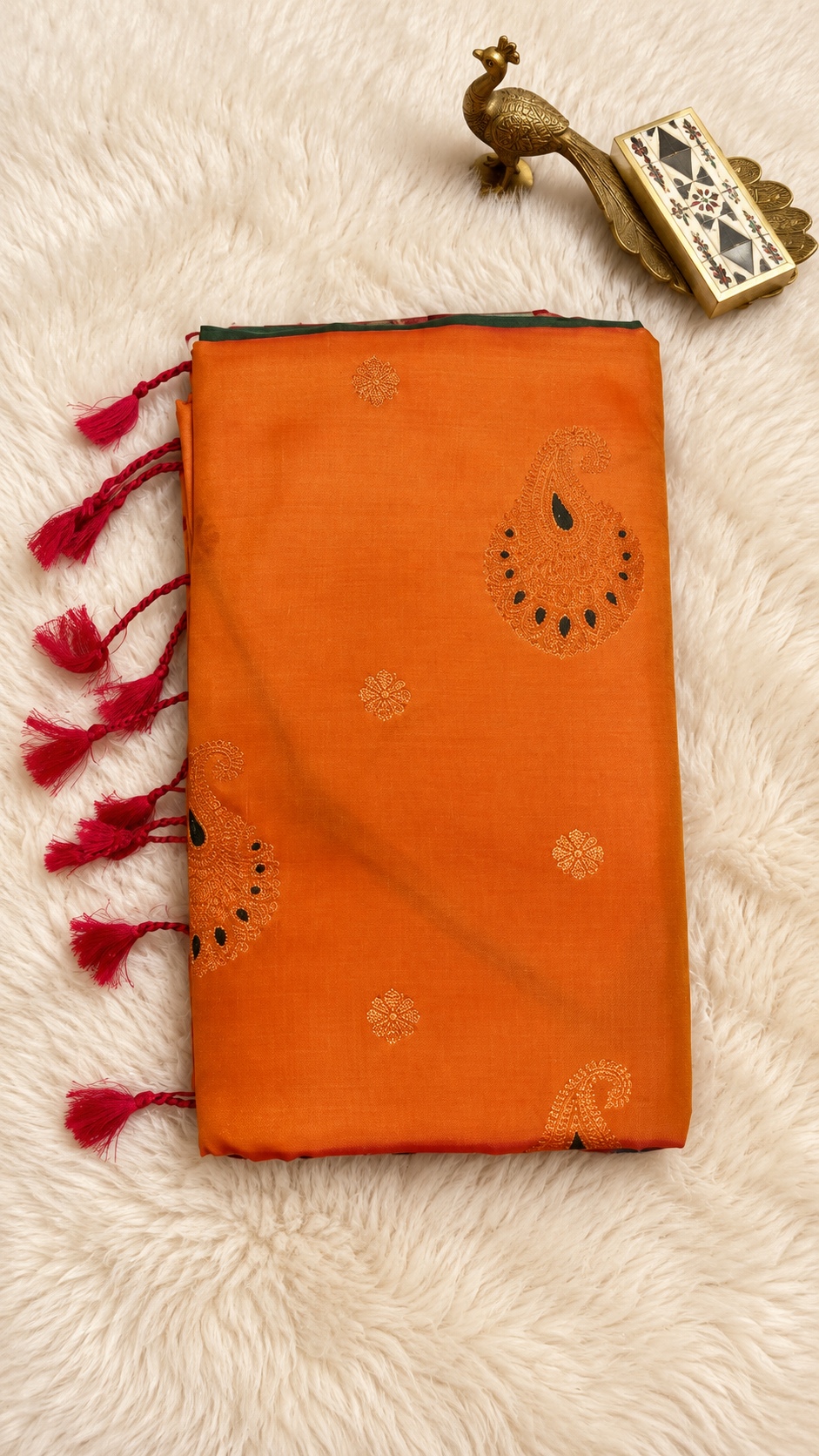 Orange soft silk saree with copper zari paisley butta and pink tassels