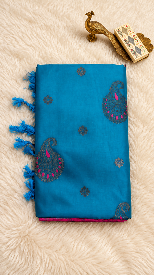 Peacock blue soft silk saree with paisley butta, pink border and tassels
